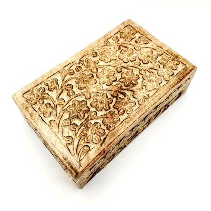hand carved flower pattern on wooden box